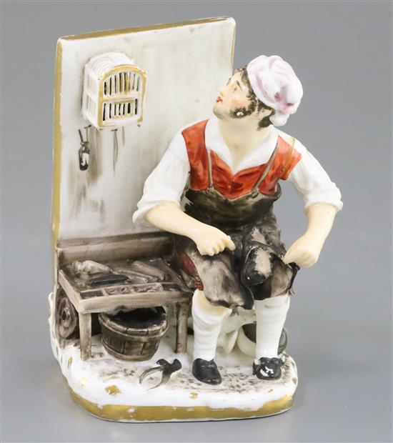 A Rockingham porcelain figure of a seated cobbler, c.1830, H.14cm, left arm re-stuck at shoulder